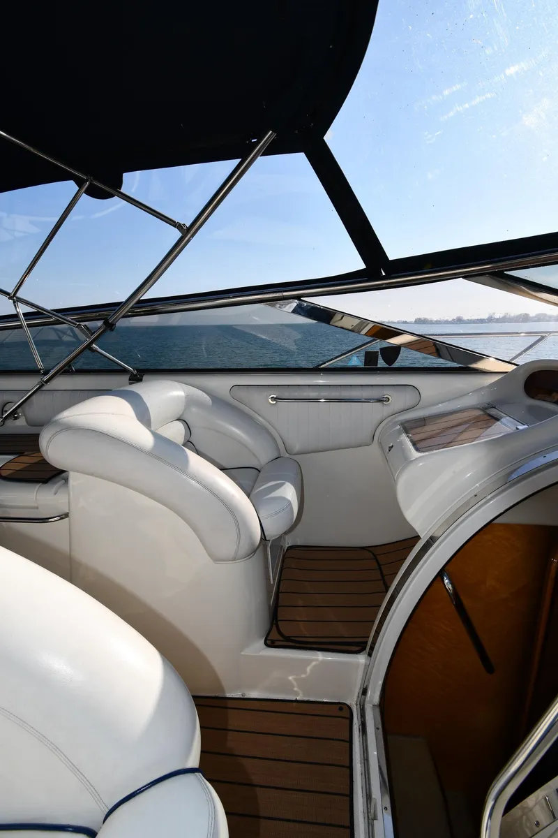Slide: The Image of 1996 Sunseeker 55 CAMARGUE yacht interior with white seating and wooden flooring. - 23