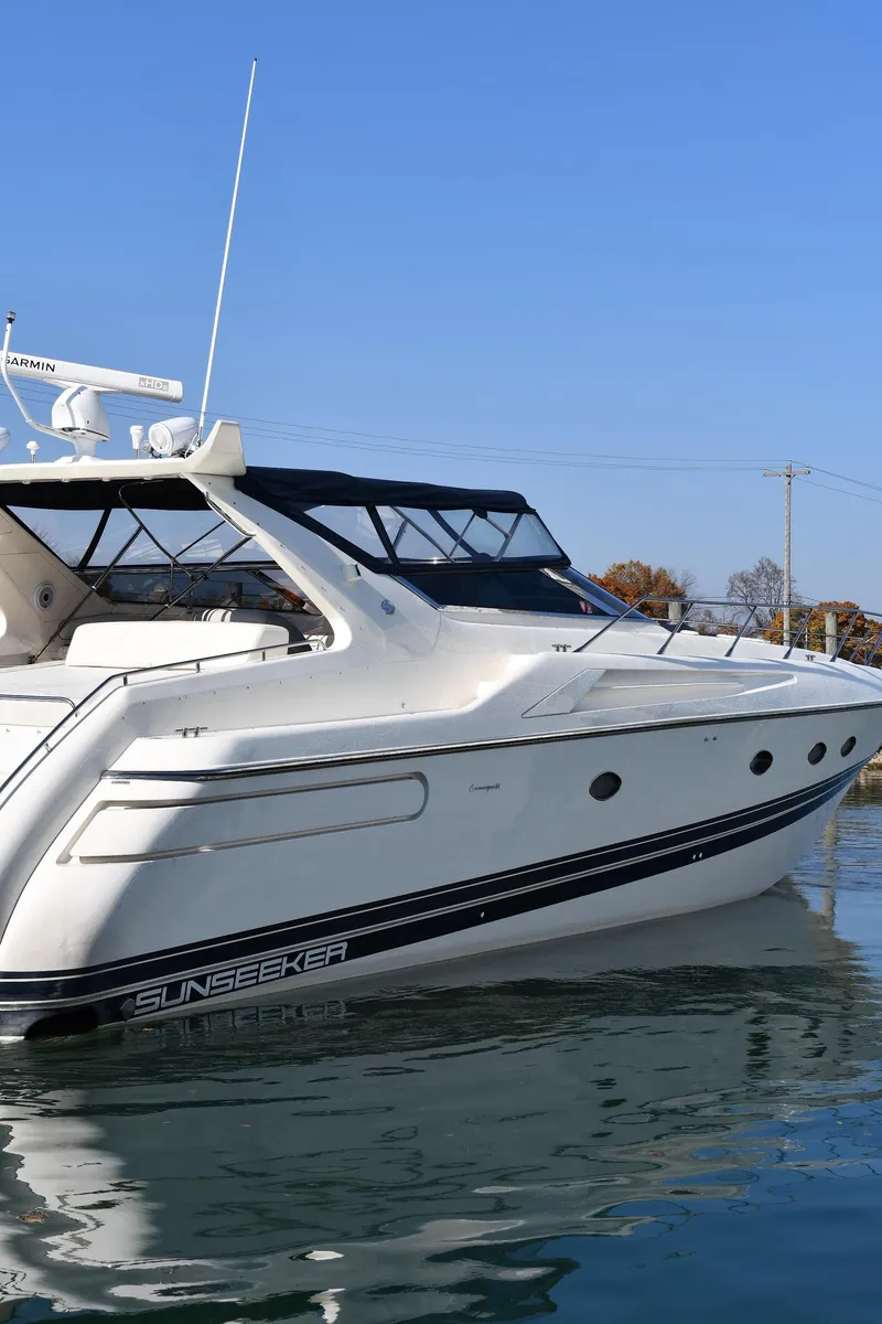 Slide: The Image of 1996 Sunseeker 55 CAMARGUE yacht on calm water, showcasing sleek design and luxury features. - 3