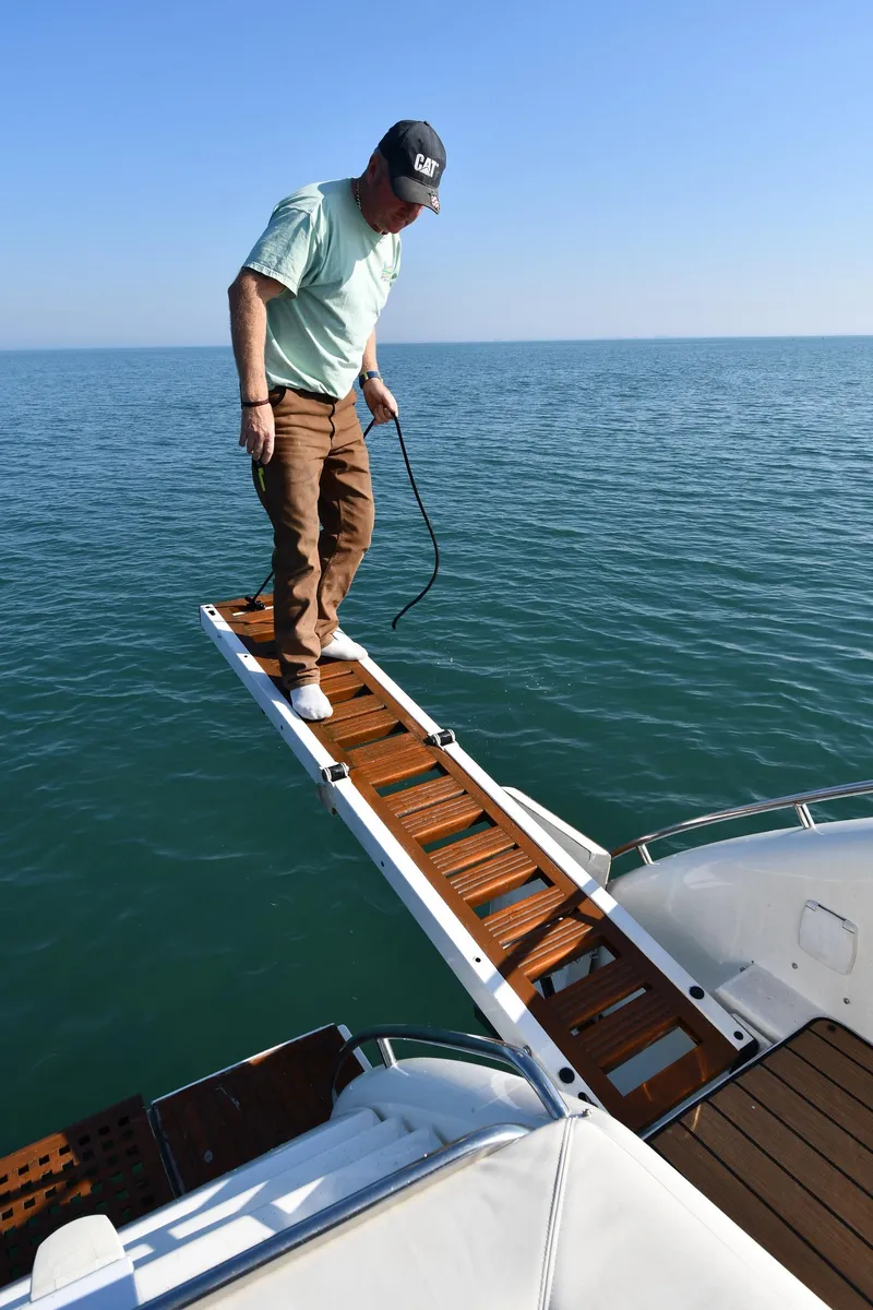 Slide: The Image of Man on Sunseeker 55 CAMARGUE yacht's gangway over water, 1996 model. - 35