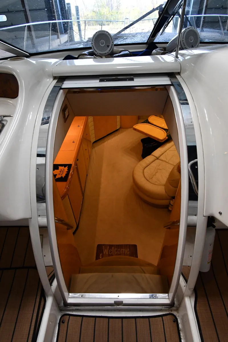 Slide: The Image of Interior view of 1996 Sunseeker 55 CAMARGUE yacht, featuring luxurious seating and wooden cabinetry. - 38