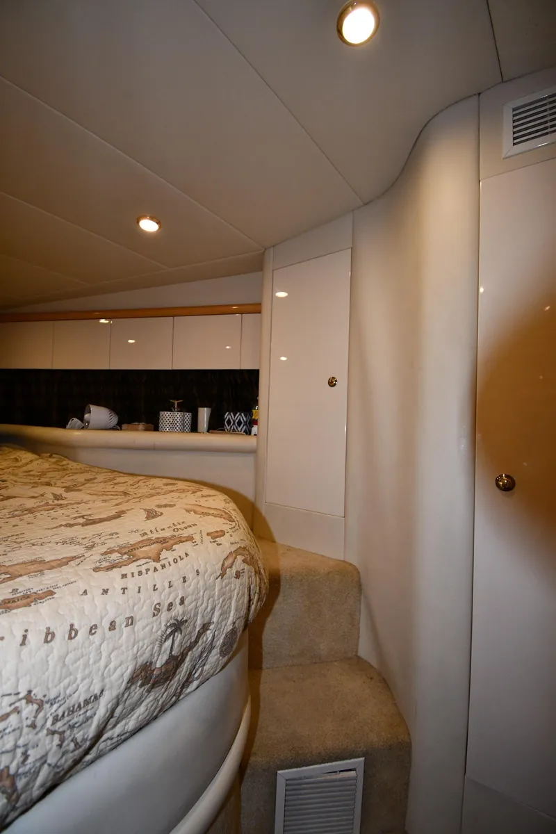 Slide: The Image of Interior of 1996 Sunseeker 55 CAMARGUE yacht, featuring cozy bedroom with map-themed bedding. - 41