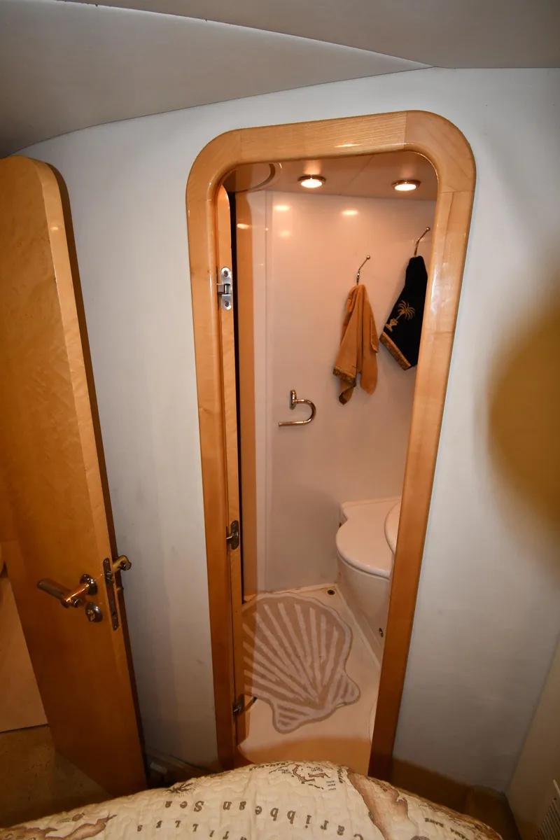 Slide: The Image of Bathroom interior of 1996 Sunseeker 55 CAMARGUE yacht, featuring compact shower and wooden accents. - 45