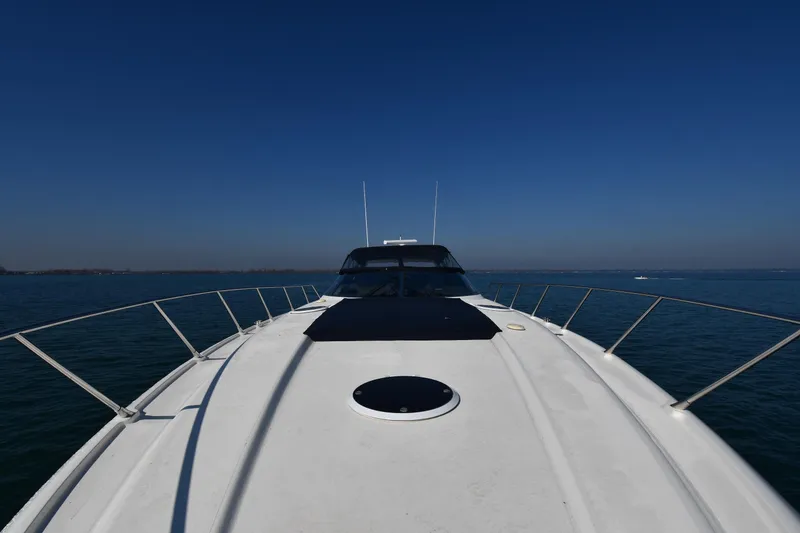 Slide: The Image of Front view of 1996 Sunseeker 55 CAMARGUE yacht on open water under clear blue sky. - 6