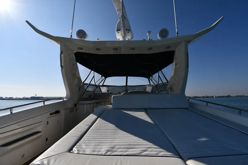 Slide: The Image of Sunseeker 55 CAMARGUE 1996 yacht deck with sunbed, ocean view, and clear blue sky. - 9
