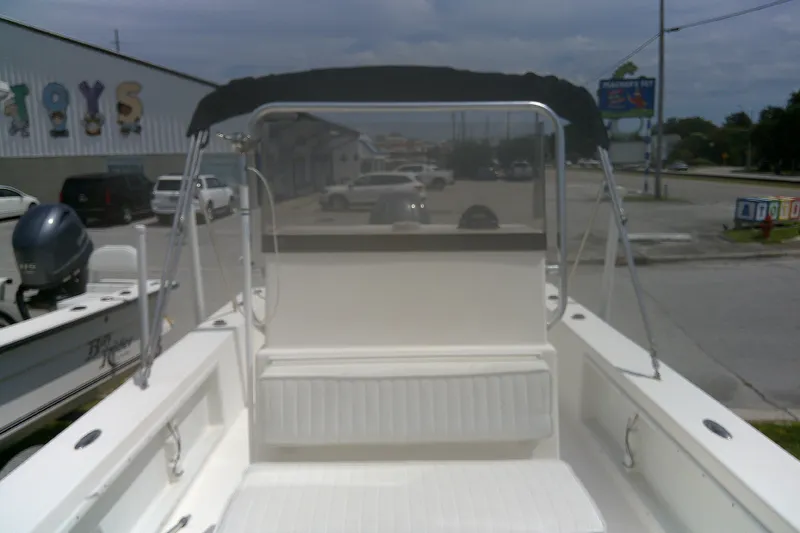 Slide: The Image of 2008 KenCraft 2260 BAYRIDER boat with canopy, parked near a toy store. - 11
