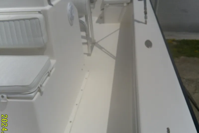Slide: The Image of 2008 KenCraft 2260 BAYRIDER boat interior with white seating and deck. - 12
