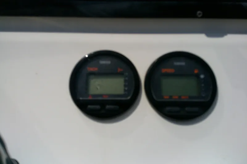 Slide: The Image of Close-up of two round digital gauges on a 2008 KenCraft 2260 BAYRIDER boat. - 24