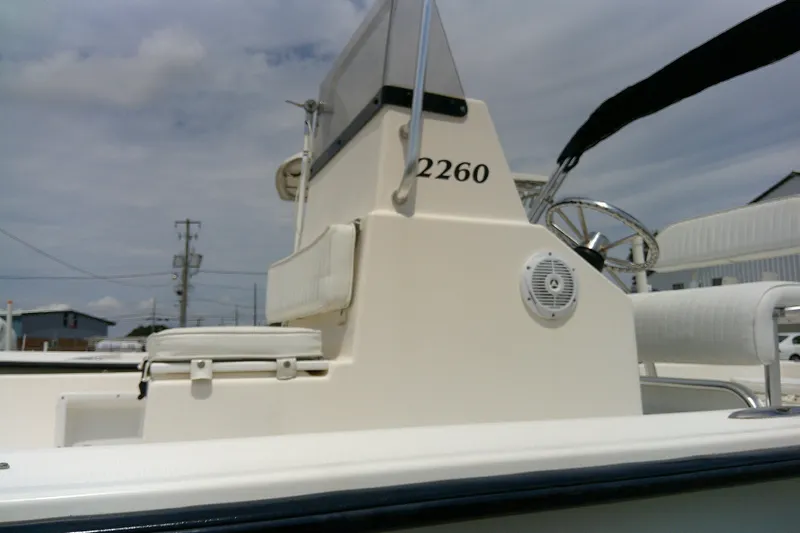 Slide: The Image of 2008 KenCraft 2260 BAYRIDER boat with steering wheel and seating, under a cloudy sky. - 5