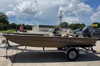The Image of 2023 SeaArk RX170 SC boat on trailer under a cloudy sky. - 1