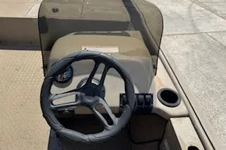 Slide: The Image of 2023 SeaArk RX170 SC boat dashboard with steering wheel and cup holder. - 5
