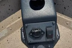 Slide: The Image of Control panel of 2023 SeaArk RX170 SC boat, featuring switches and a cup holder. - 7