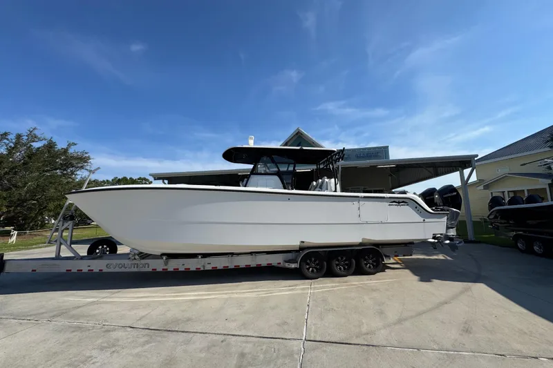 The Image of 2023 Invincible 35 Catamaran on trailer under clear blue sky. - 1