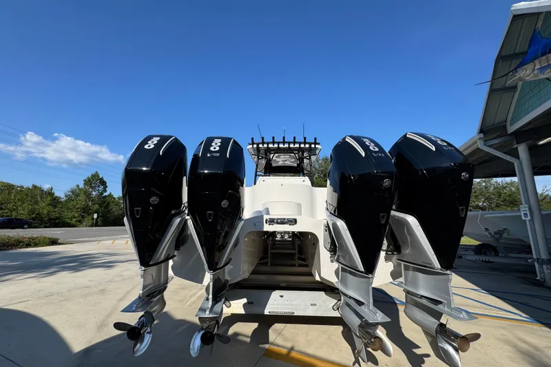 Slide: The Image of 2023 Invincible 35 Catamaran with four powerful outboard engines, parked outdoors. - 15