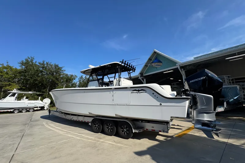Slide: The Image of 2023 Invincible 35 Catamaran on trailer, parked outside a marine facility. - 18
