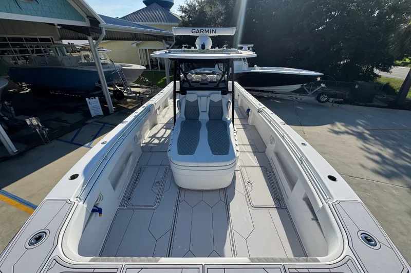 Slide: The Image of 2023 Invincible 35 Catamaran with spacious deck and modern seating, docked outdoors. - 19