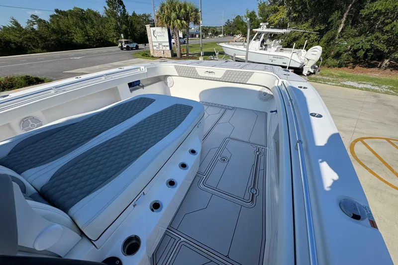 Slide: The Image of 2023 Invincible 35 Catamaran with spacious deck and comfortable seating, parked outdoors. - 23