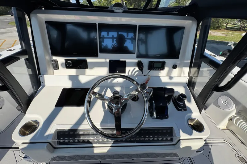 Slide: The Image of 2023 Invincible 35 Catamaran helm with modern controls and multiple display screens. - 33