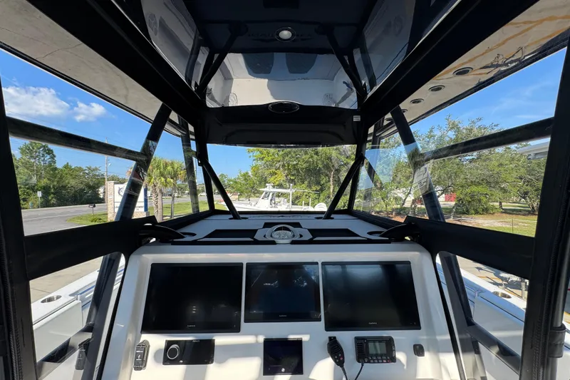 Slide: The Image of 2023 Invincible 35 Catamaran cockpit with advanced navigation displays and panoramic views. - 34