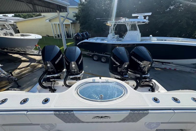 Slide: The Image of 2023 Invincible 35 Catamaran with Mercury engines, docked alongside other boats. - 39