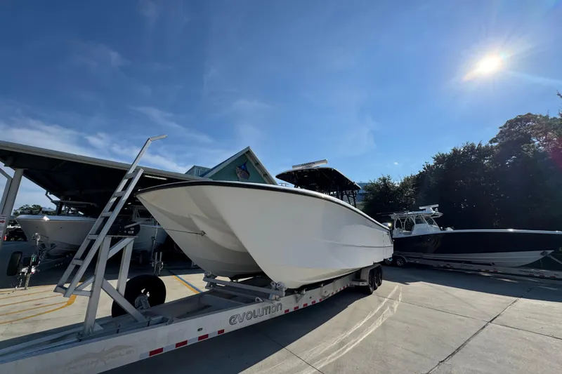 Slide: The Image of 2023 Invincible 35 Catamaran on trailer under clear blue sky. - 4