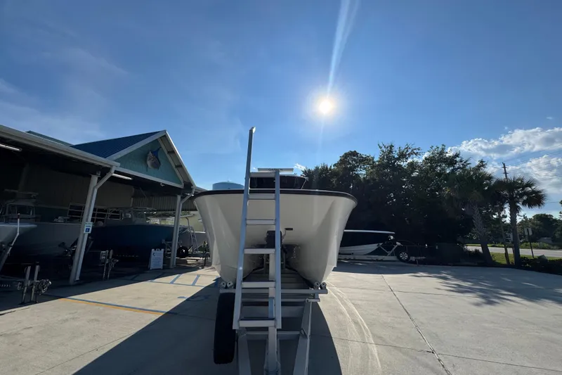 Slide: The Image of 2023 Invincible 35 Catamaran in sunny outdoor showroom setting. - 6