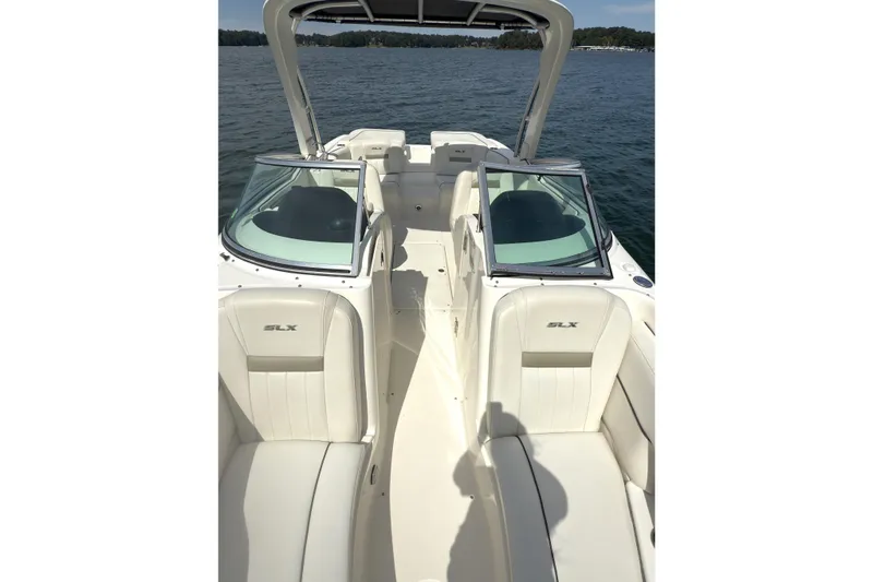 Slide: The Image of 2007 Sea Ray 250 SLX boat interior with white seating and open water view. - 10