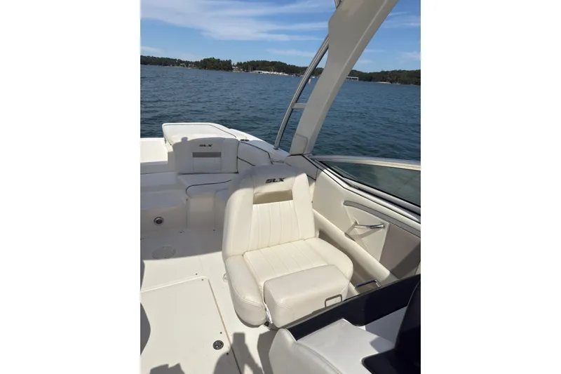Slide: The Image of 2007 Sea Ray 250 SLX boat interior with white seating on a sunny day. - 12