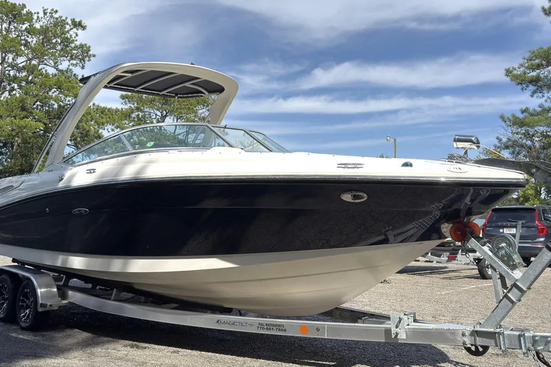 Slide: The Image of 2007 Sea Ray 250 SLX boat on trailer, parked outdoors under a clear blue sky. - 16
