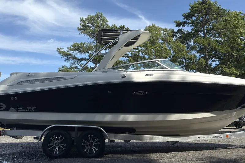 Slide: The Image of 2007 Sea Ray 250 SLX boat on trailer, parked outdoors under clear sky. - 18