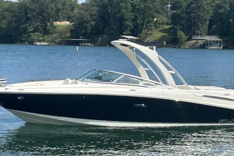 Slide: The Image of 2007 Sea Ray 250 SLX boat on a serene lake with lush green surroundings. - 3
