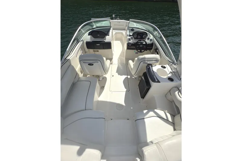 Slide: The Image of 2007 Sea Ray 250 SLX boat interior with white seating and steering console. - 4