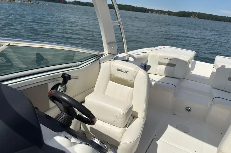 Slide: The Image of 2007 Sea Ray 250 SLX boat interior with white seating on a sunny day. - 7