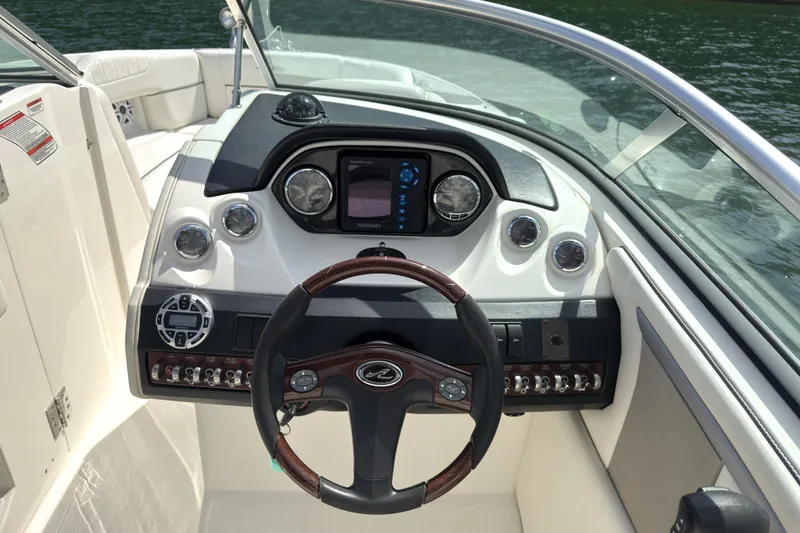Slide: The Image of 2007 Sea Ray 250 SLX boat dashboard with steering wheel and control panel. - 8