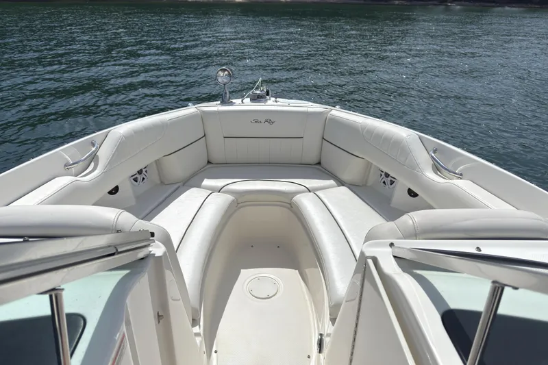 Slide: The Image of 2007 Sea Ray 250 SLX boat interior with white seating on calm water. - 9
