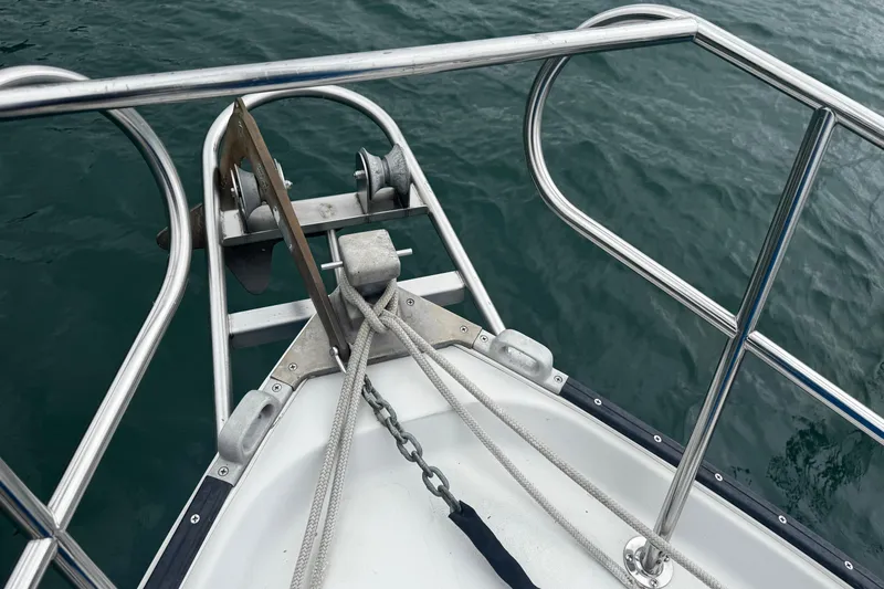 Slide: The Image of Bow of 1984 Nonsuch 26 Classic sailboat with anchor and railing over water. - 13