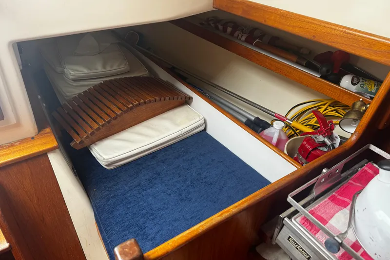 Slide: The Image of Interior storage of 1984 Nonsuch 26 Classic sailboat with cushions and equipment. - 17