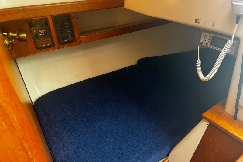 Slide: The Image of 1984 Nonsuch 26 Classic cabin interior with blue cushions and control panel. - 18