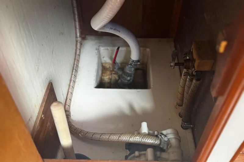 Slide: The Image of 1984 Nonsuch 26 Classic boat interior plumbing system with hoses and fittings. - 25