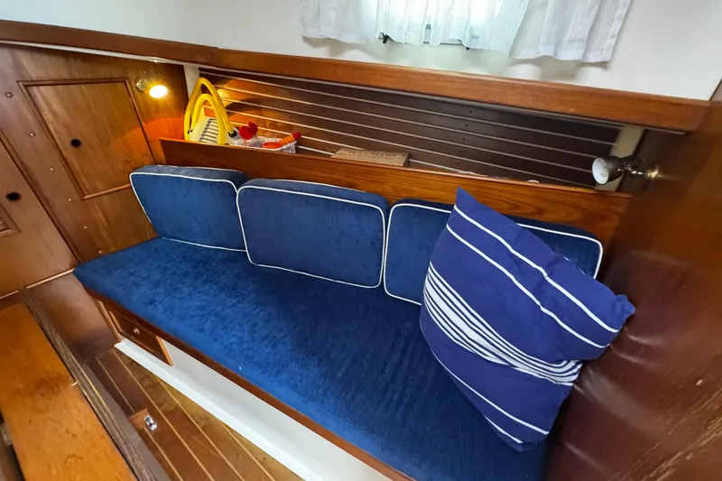 Slide: The Image of Cozy interior of 1984 Nonsuch 26 Classic sailboat with blue cushions and striped pillow. - 29