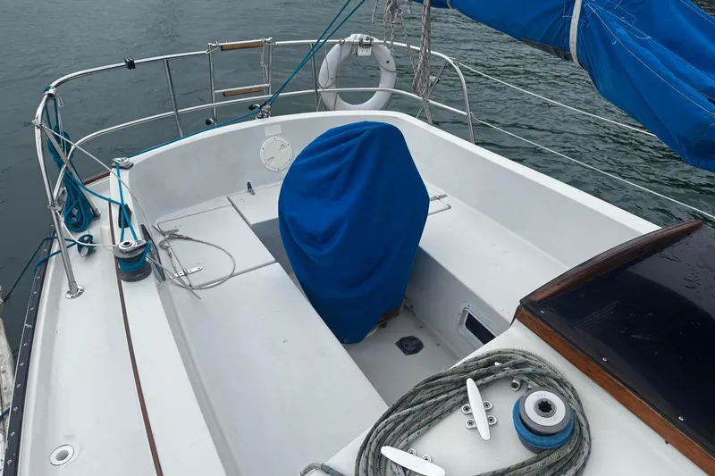 Slide: The Image of 1984 Nonsuch 26 Classic sailboat cockpit with blue cover and nautical equipment. - 37