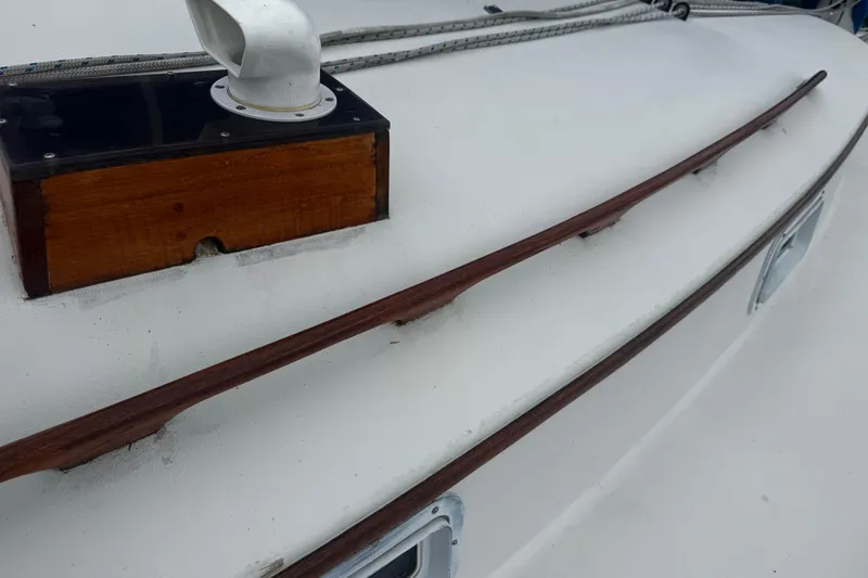Slide: The Image of 1984 Nonsuch 26 Classic deck with wooden trim and white fittings. - 38