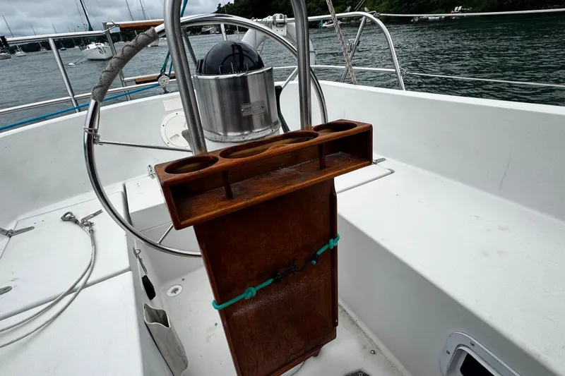 Slide: The Image of Cockpit of 1984 Nonsuch 26 Classic sailboat with wooden cup holder and steering wheel. - 4