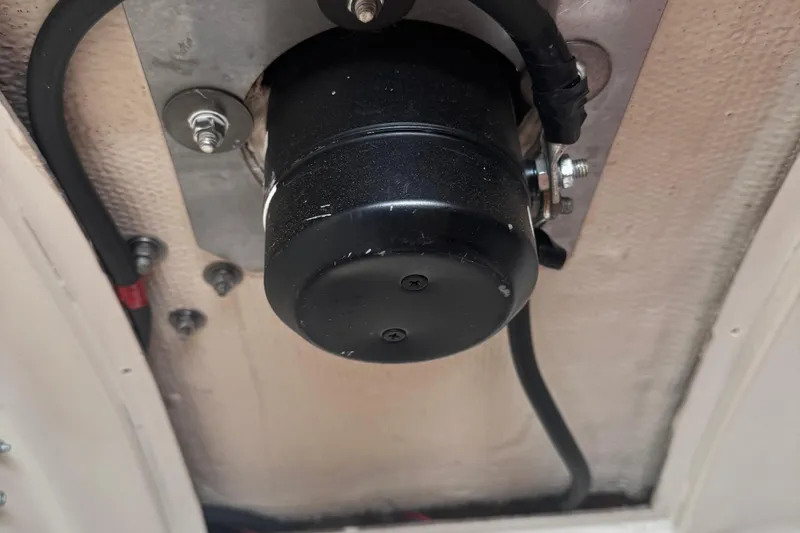 Slide: The Image of 1984 Nonsuch 26 Classic boat component, black cylindrical part with wiring and bolts. - 9