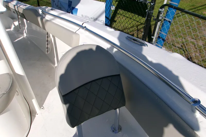 Slide: The Image of 2026 Key West 239 FS boat interior with cushioned seating and stainless steel railing. - 11