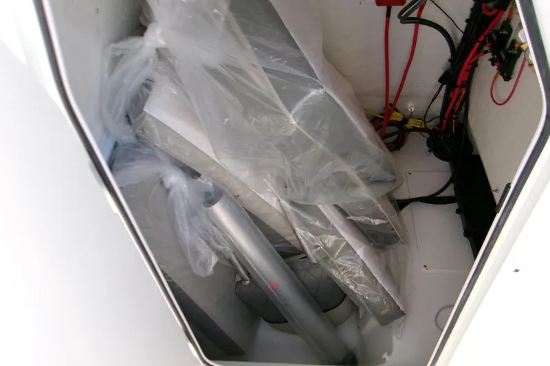 Slide: The Image of Storage compartment of 2026 Key West 239 FS boat with equipment and wiring. - 13