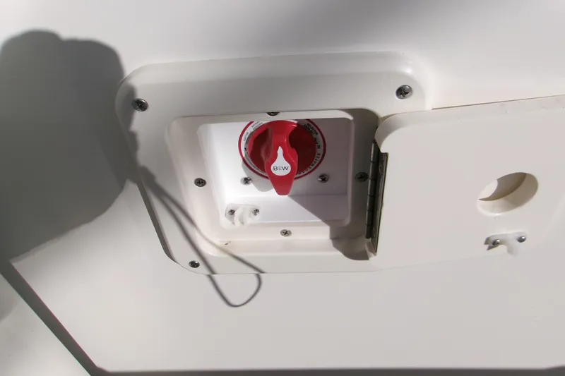 Slide: The Image of Battery switch on 2026 Key West 239 FS boat, white panel with red knob. - 15
