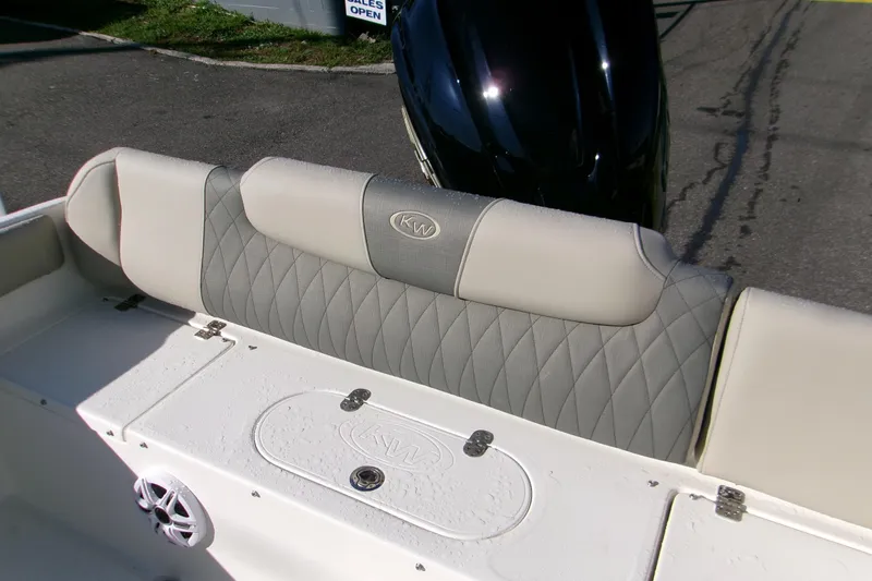 Slide: The Image of 2026 Key West 239 FS boat interior with cushioned seating and storage compartment. - 3