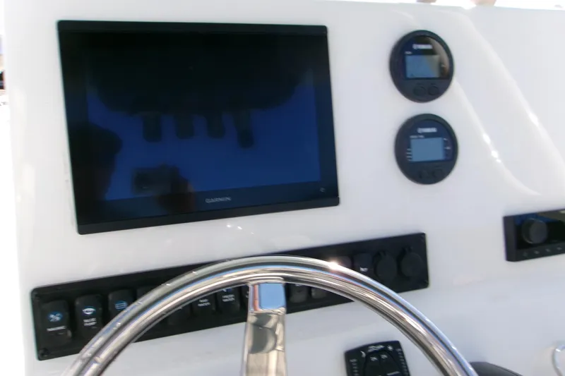 Slide: The Image of Steering console of 2026 Key West 239 FS boat with Garmin display and controls. - 5