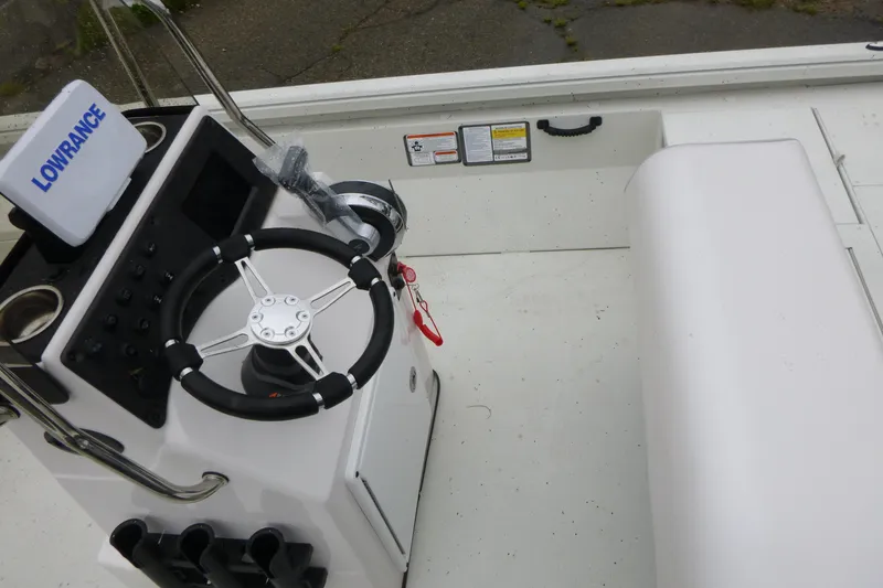 Slide: The Image of 2025 Ranger RB210 boat cockpit with steering wheel and Lowrance navigation system. - 13