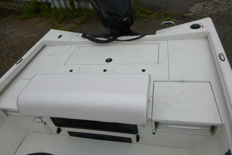 Slide: The Image of 2025 Ranger RB210 boat deck with storage compartments and motor. - 15